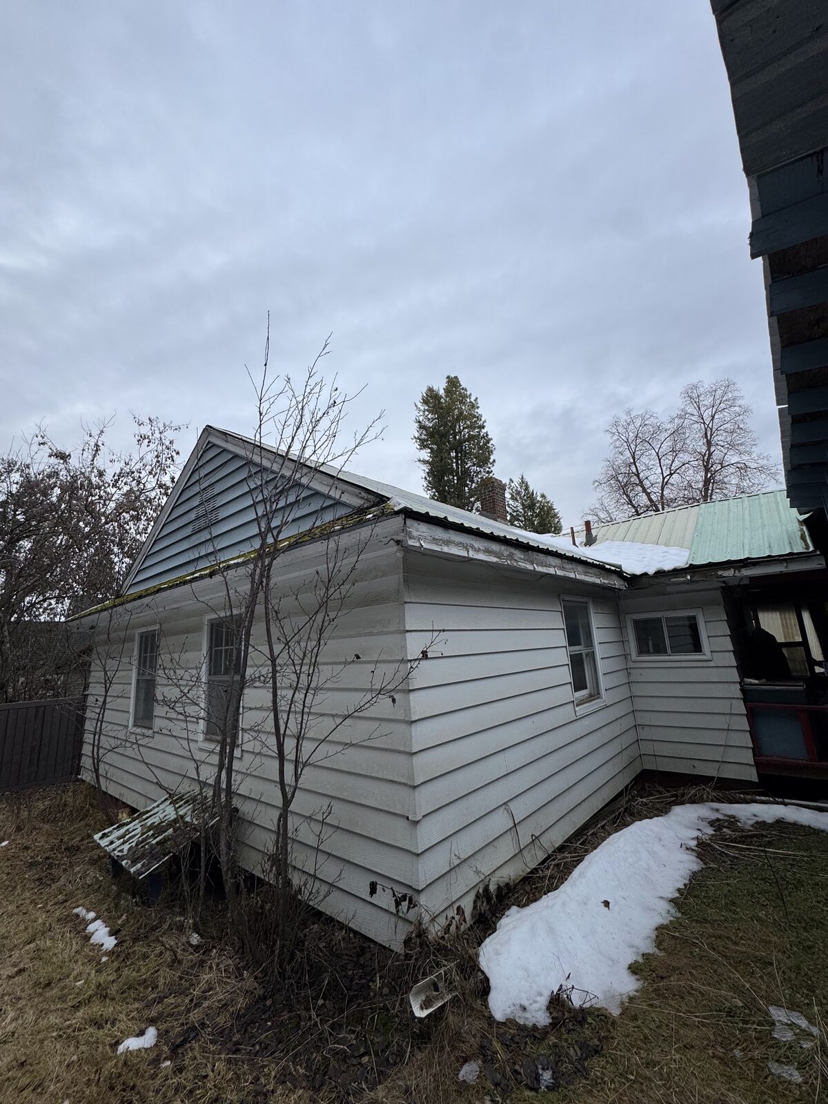 6972 Oak St before rehab, rear exterior